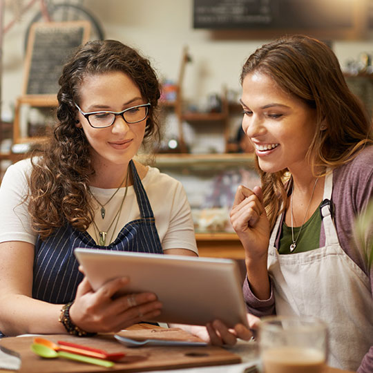 workers in overalls looking at tablet