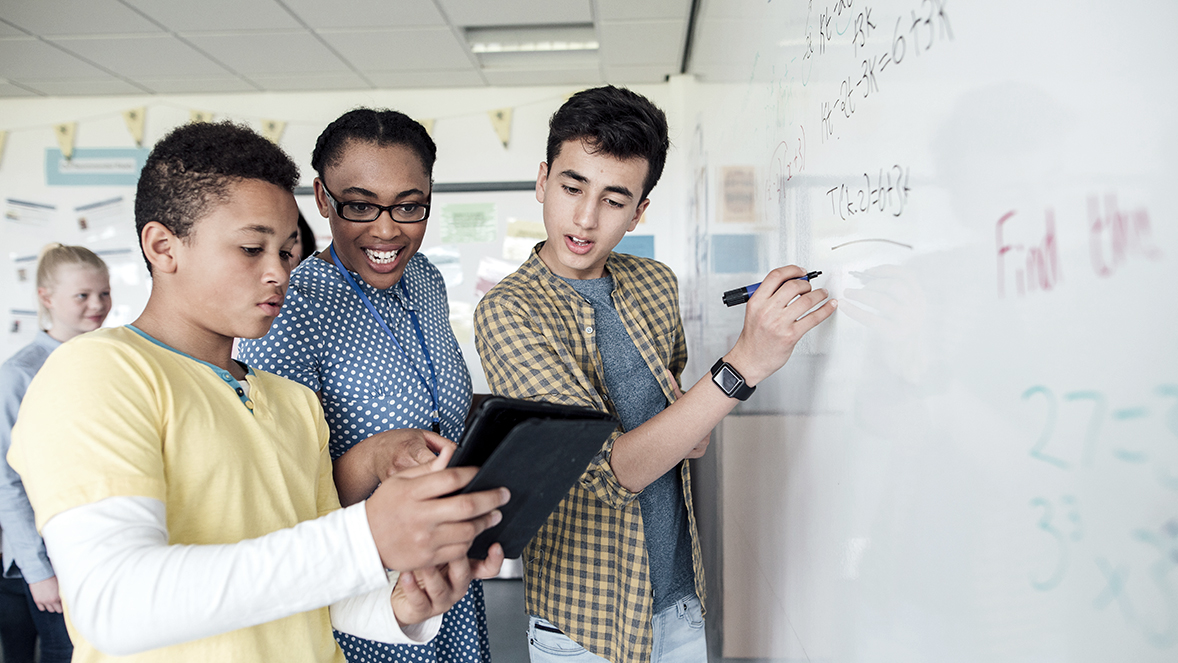 young people writing on a whiteboard