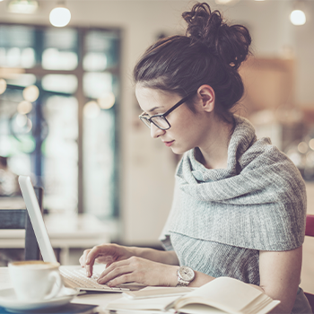 woman working on laptop in cafe